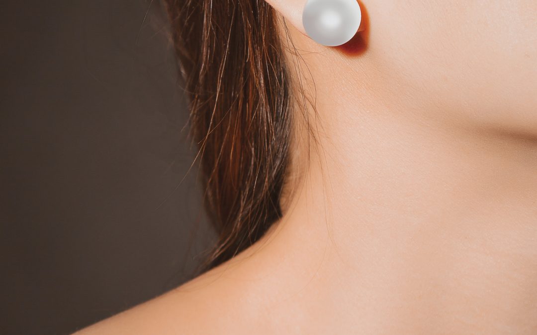 Evoke Vs. FaceTite Reno NV - woman's neckline and right ear with pearl earring